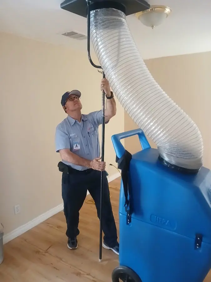 Furnace Tune-Up technician using HEPA equipment in Brooksville